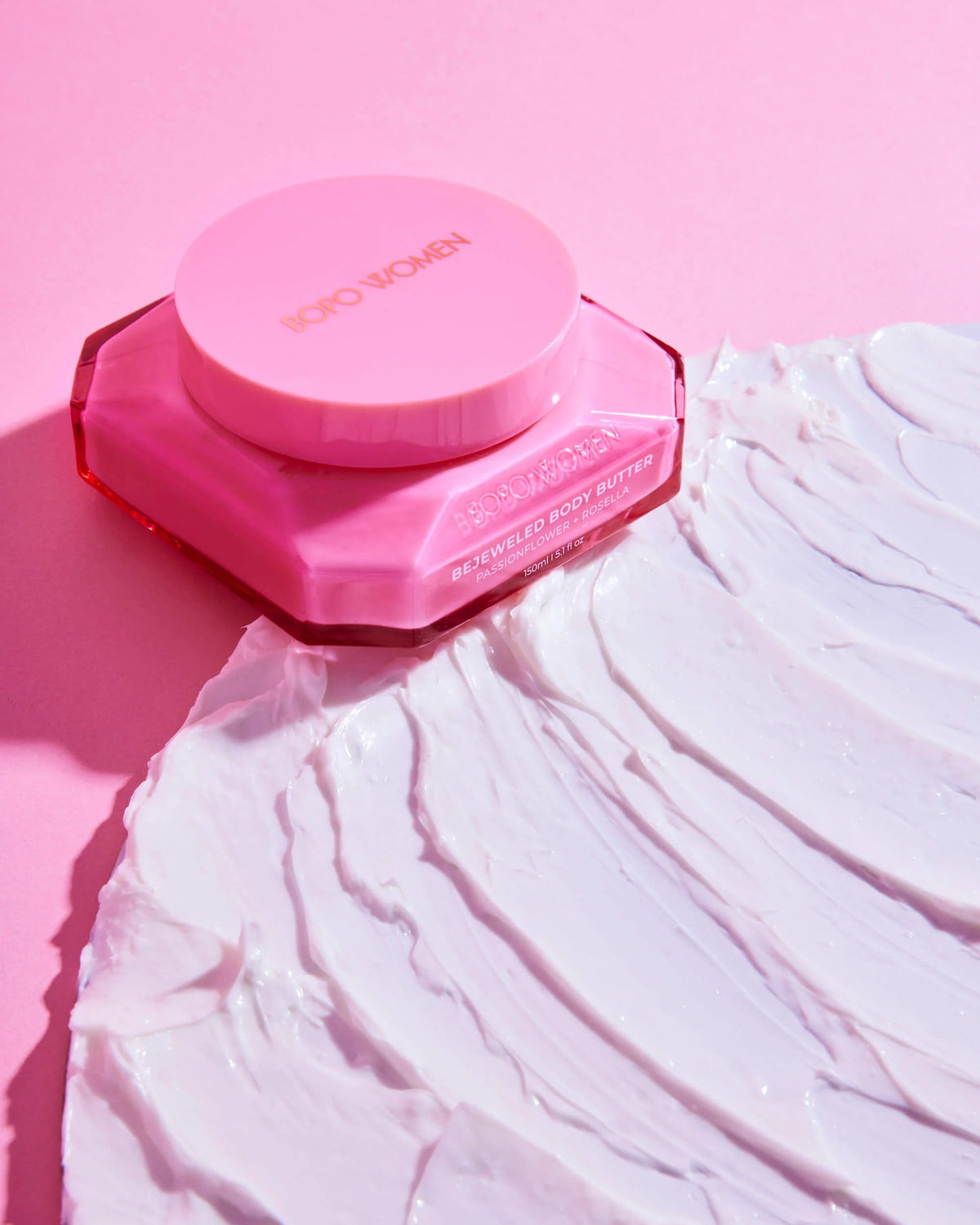 Pink compact powder case on a pink background