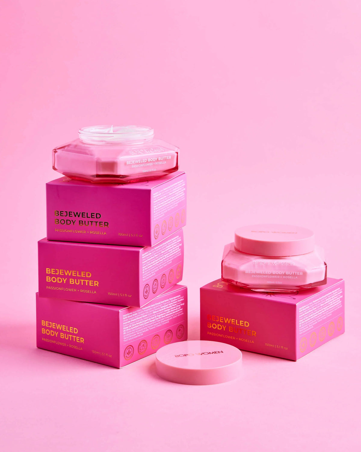 Pink 'Bejeweled Body Butter' packaging on a pink background