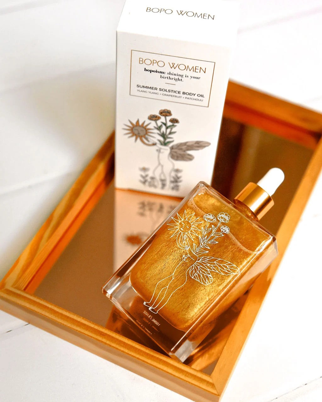 Bodo Women's perfume bottle and packaging on a reflective surface