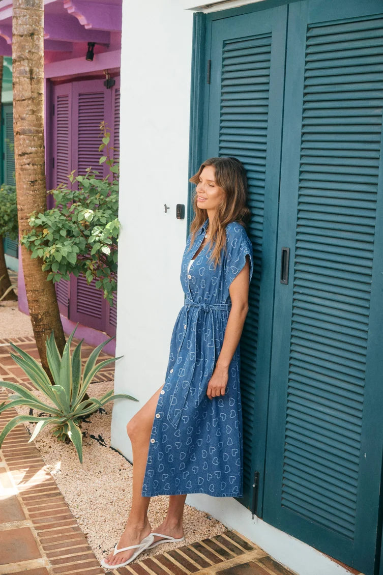 A woman wearing a blue patterned midi dress 