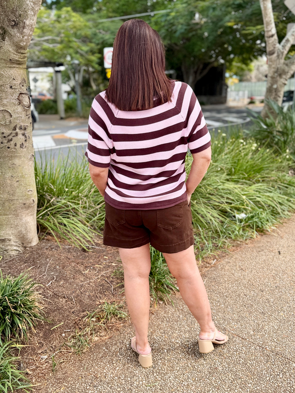 short-sleeve V-neck top with horizontal dark brown and light pink stripes, paired with brown shorts, 