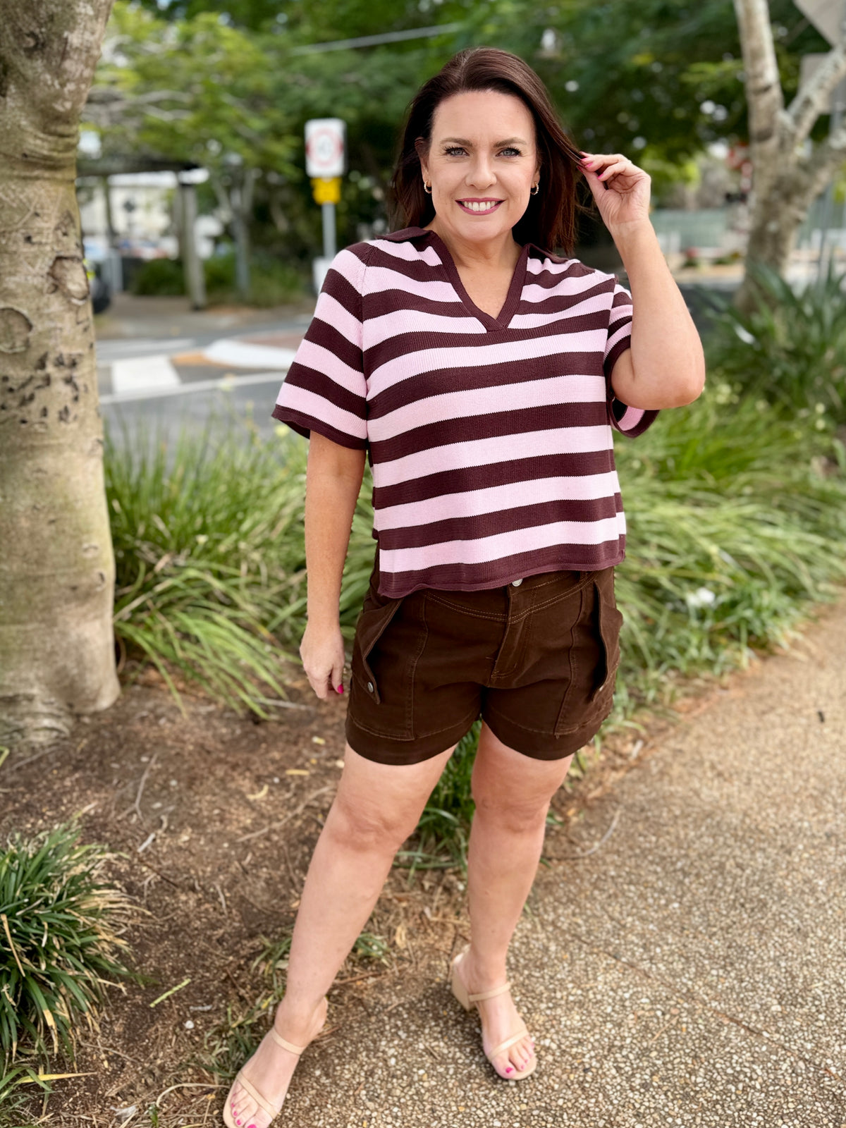 short-sleeve V-neck top with horizontal dark brown and light pink stripes, paired with brown shorts, 