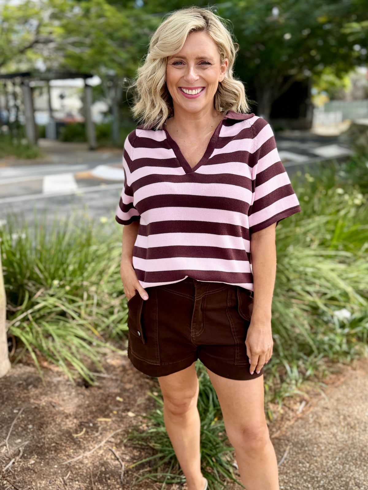 short-sleeve V-neck top with horizontal dark brown and light pink stripes, paired with brown shorts, 