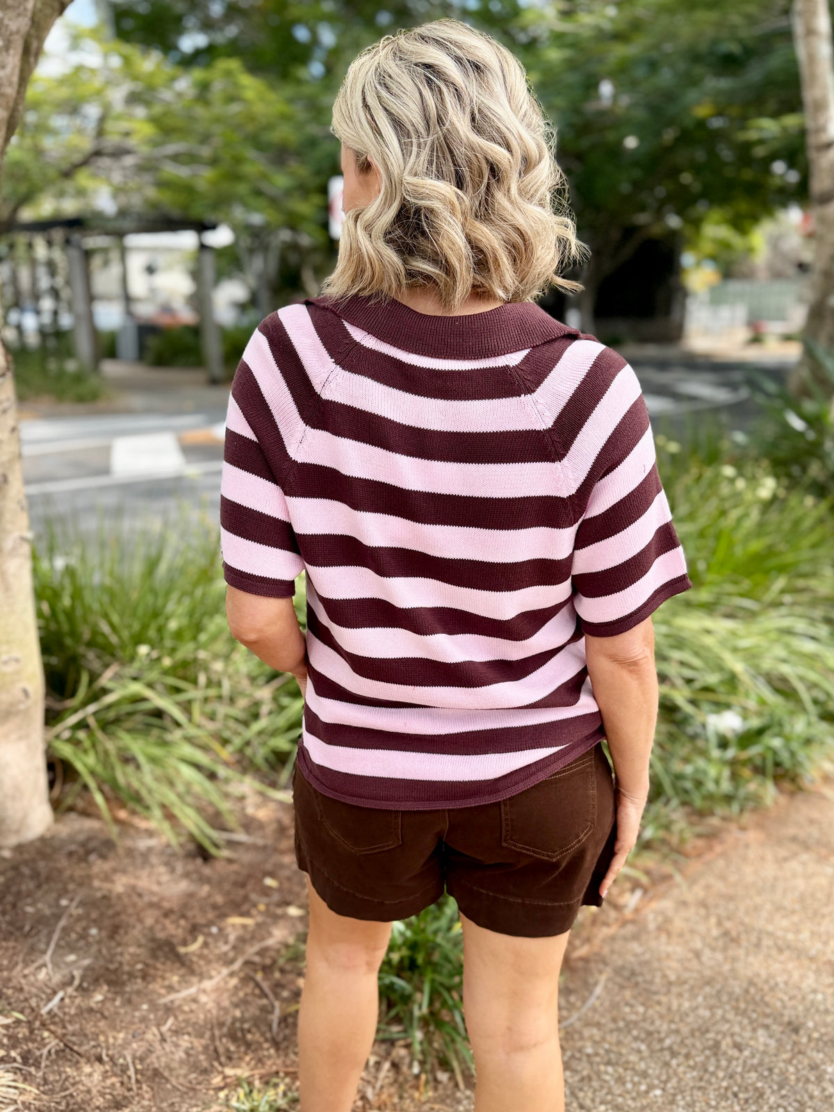short-sleeve V-neck top with horizontal dark brown and light pink stripes, paired with brown shorts, 