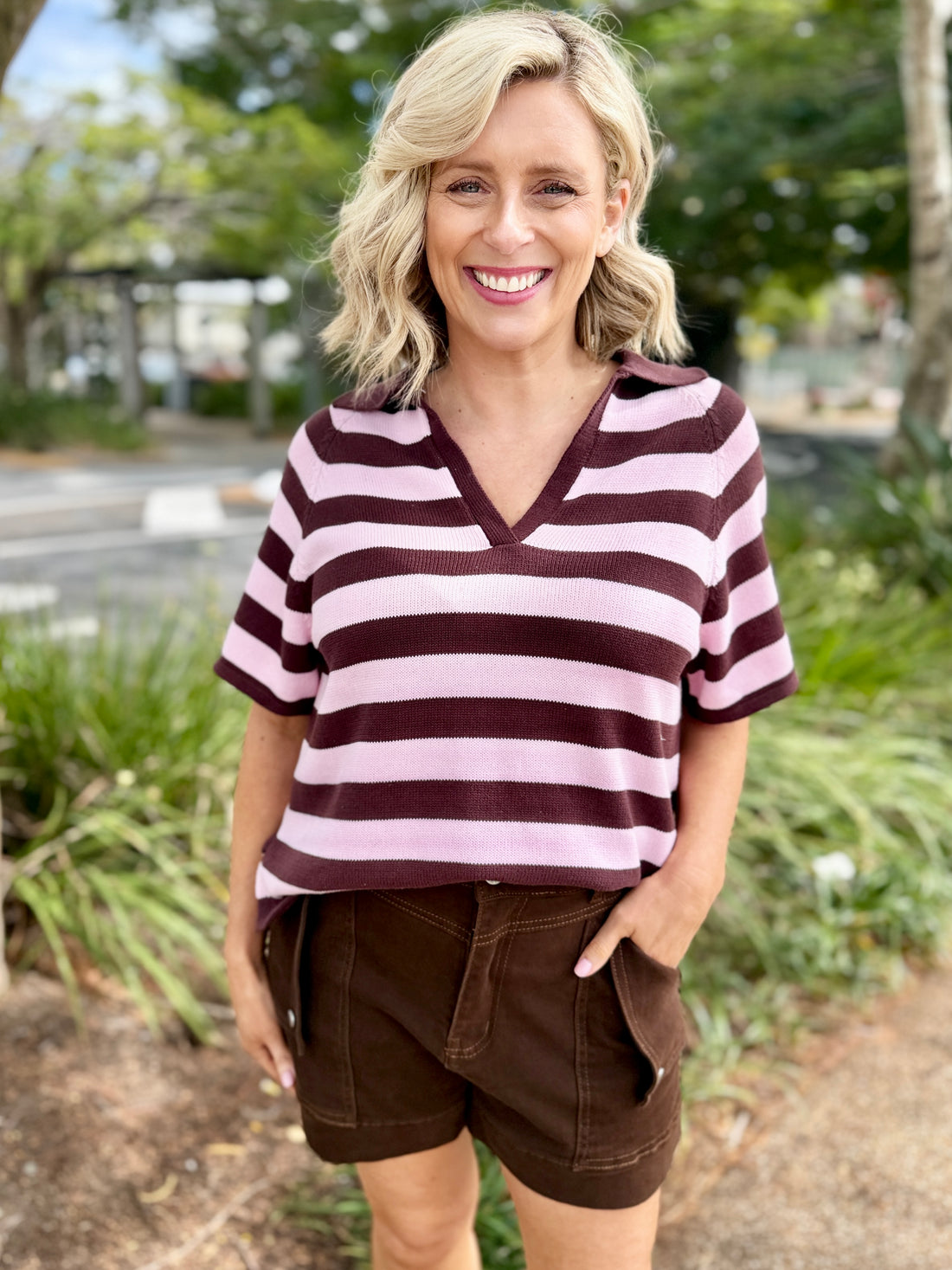 short-sleeve V-neck top with horizontal dark brown and light pink stripes, paired with brown shorts, 
