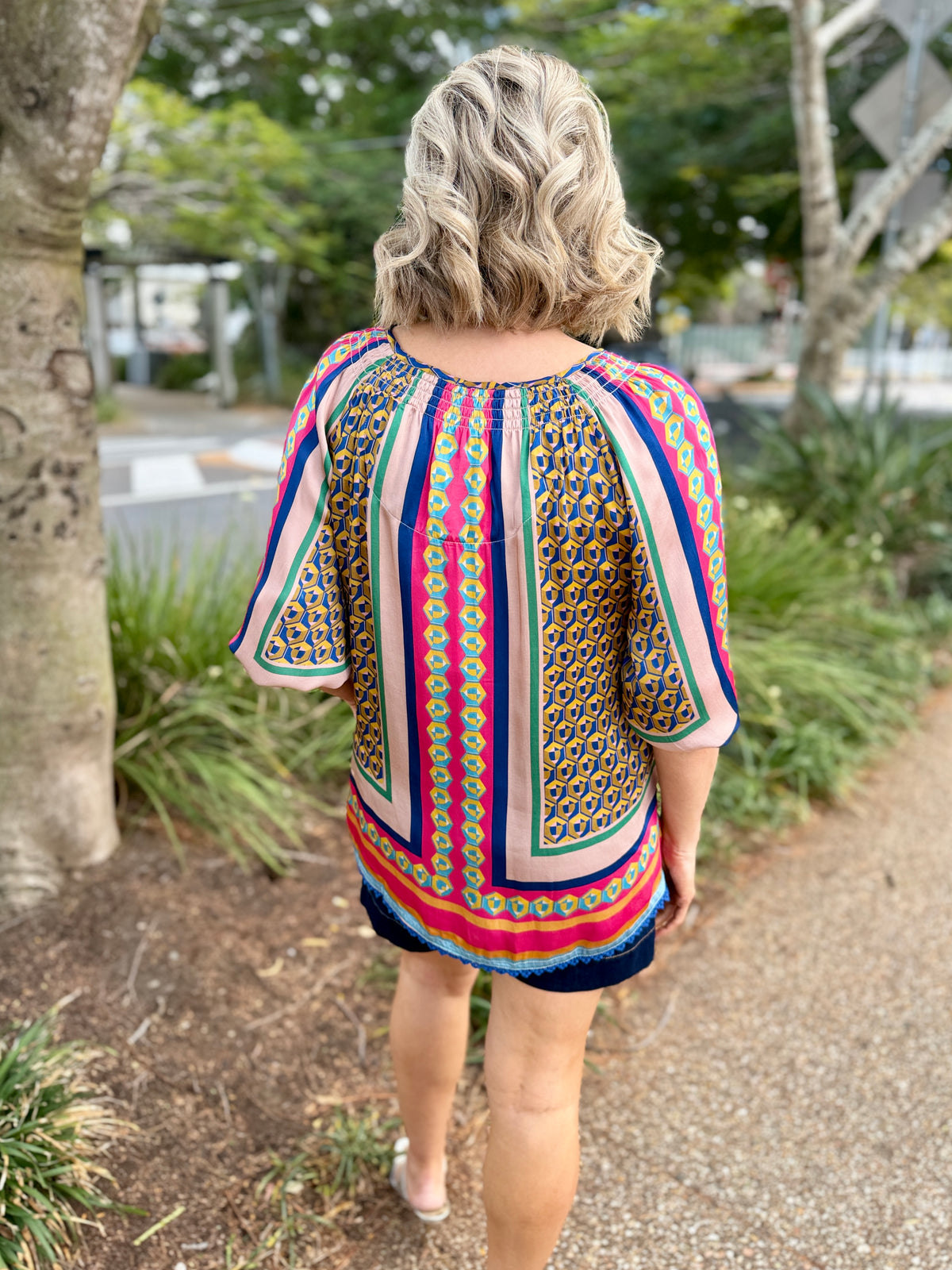  patterned short-sleeve top and dark shorts 