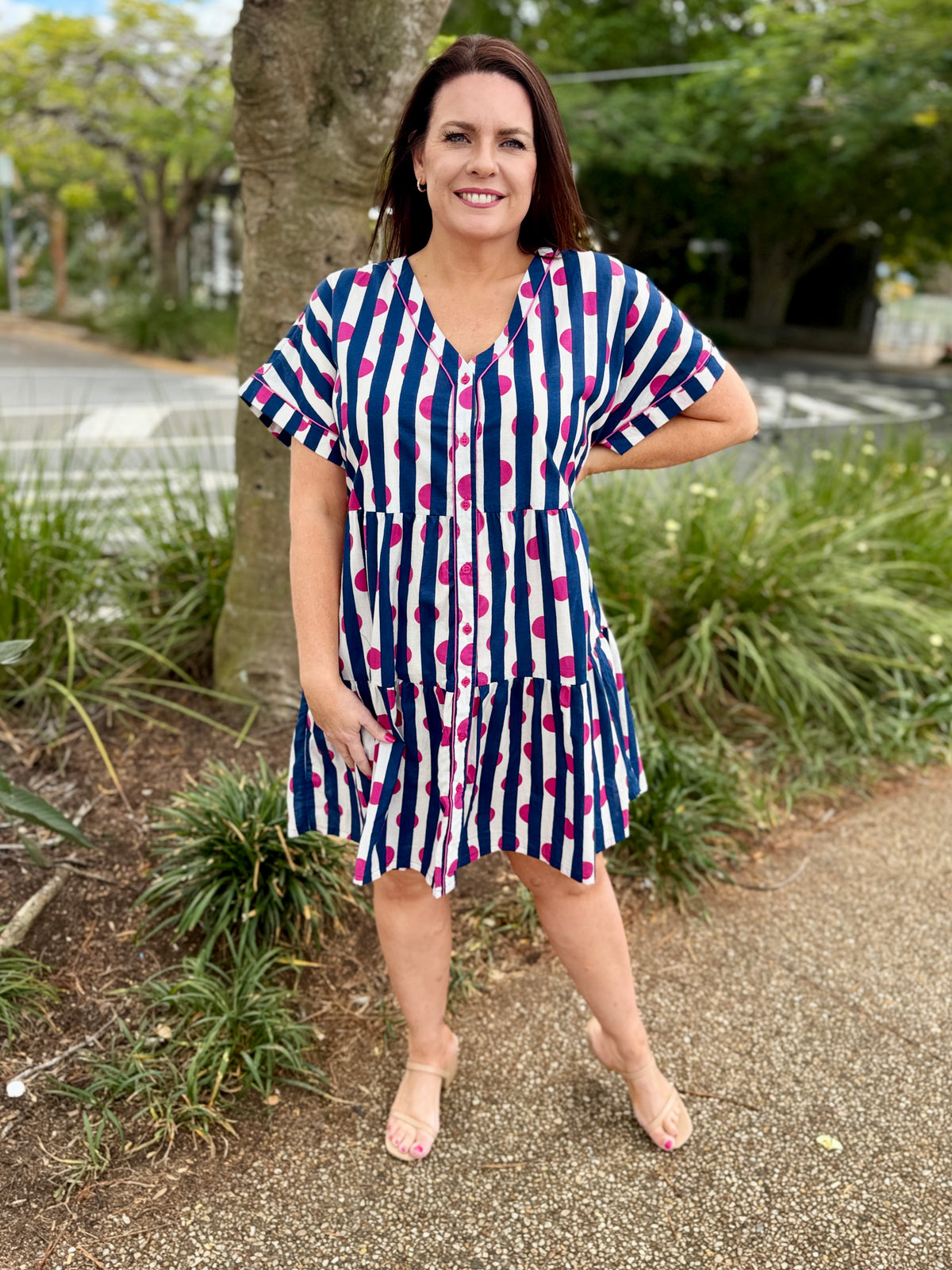 short-sleeve tiered dress with vertical navy, white, and pink polka dots, 