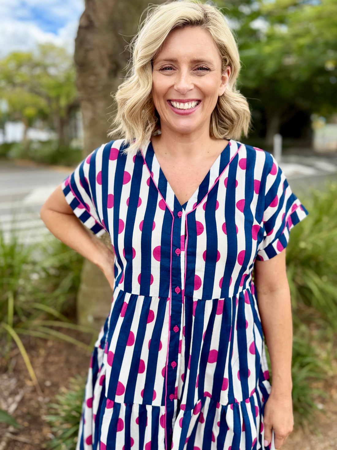 short-sleeve tiered dress with vertical navy, white, and pink stripes 