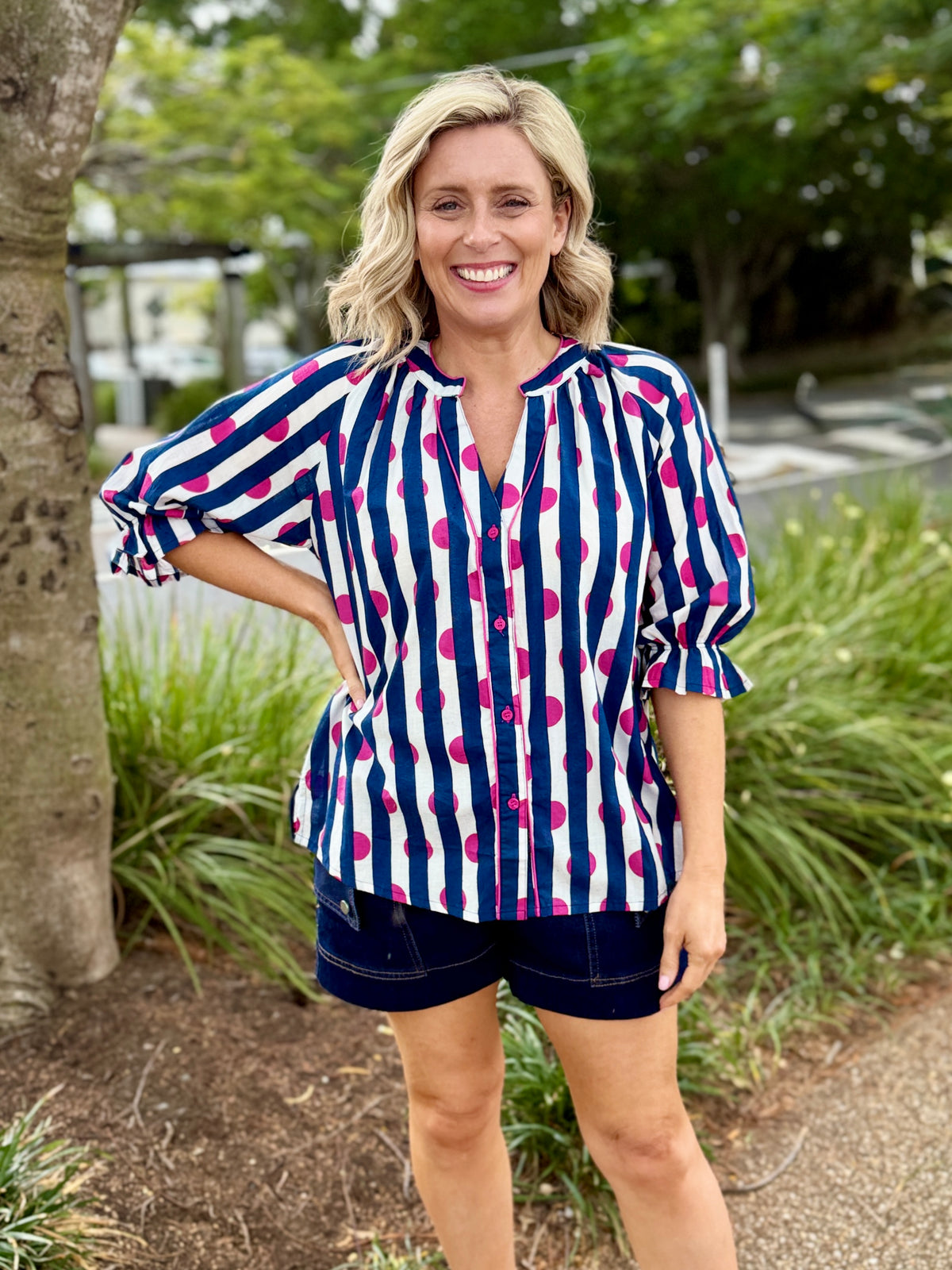 Hot pink shirt on Navy & white Stripe Backround