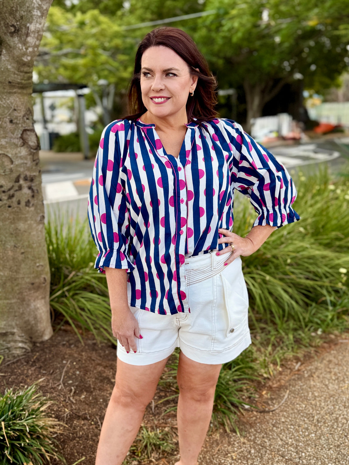  navy blue and white striped blouse with pink polka dots and white denim shorts, 