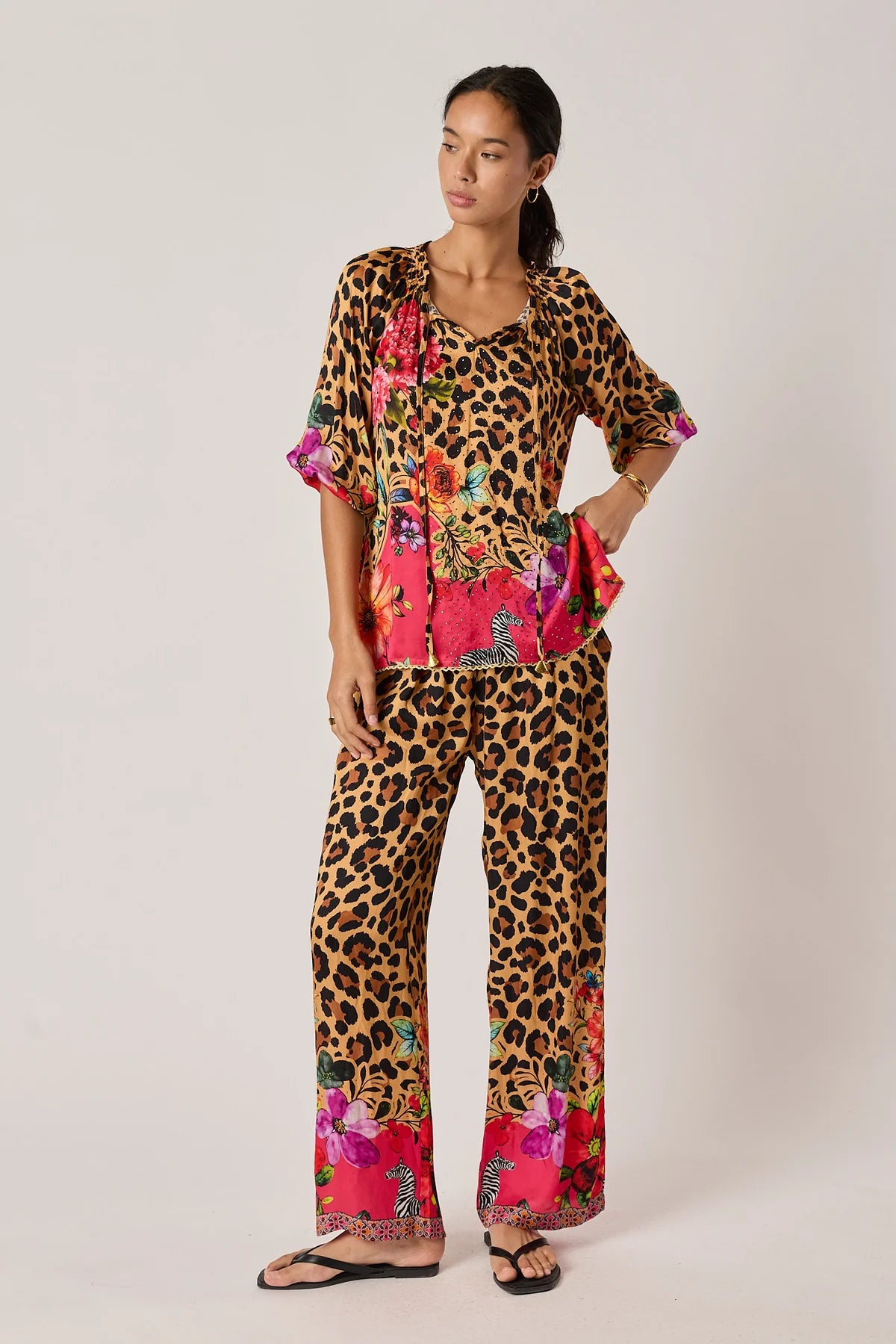  long-sleeve blouse with a leopard print upper section and a bright pink tropical floral print lower section